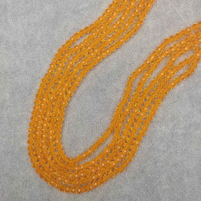 Koraliki z czeskiego kryształu – pomarańczowe, przezroczyste, fasetowane rondelki, średnica 6×5 mm, długość 41 mm, na żyłce