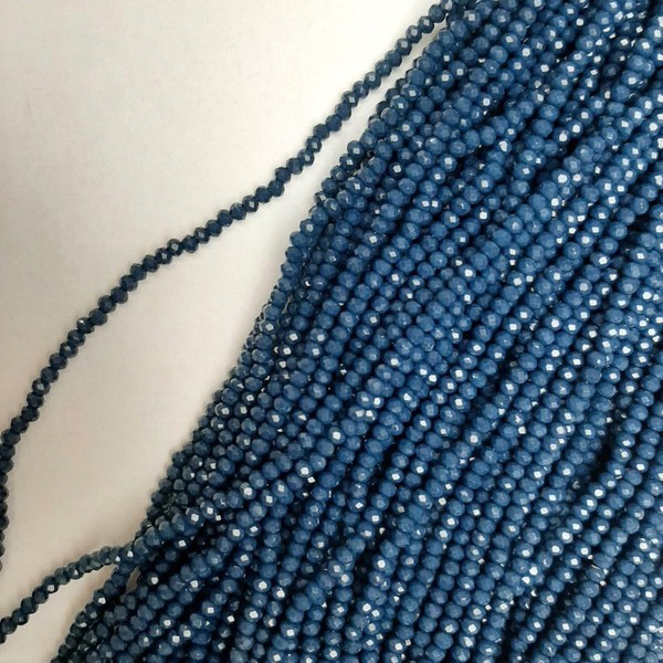 Koraliki czeskiego kryształu w ciemnoniebieskim odcieniu, fasetowane, w kształcie rondelka, średnica 3×2,5 mm, długość 39 mm +/- na żyłce