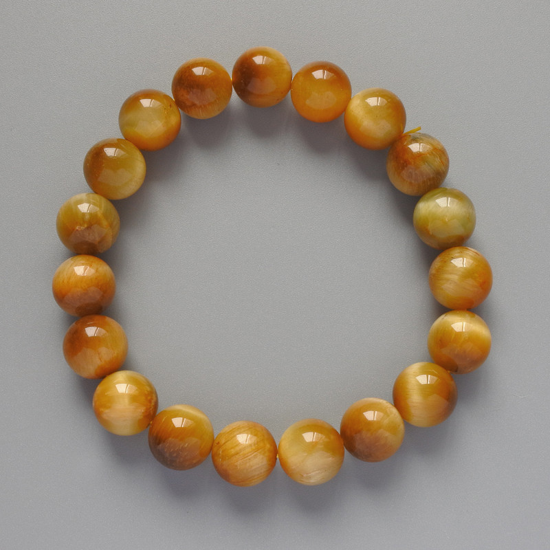Bransoletka z żółtym kocim okiem – naturalny kamień, gładka kulka, średnica około 10 mm, długość około 18 cm (rozciągliwa)