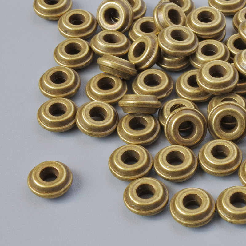 Koralik-wstawka, średnica 6×2,5 mm, średnica otworu 2,1 mm, opakowanie 60 szt. ±, kolor metalu brązowy