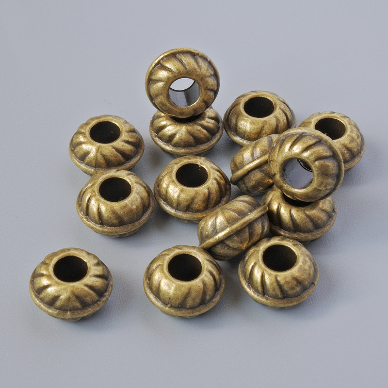 Koralik-wkładka do biżuterii, średnica 9×5,5 mm, średnica otworu 3,6 mm, opakowanie 14 szt. ±, kolor metalu: brązowy