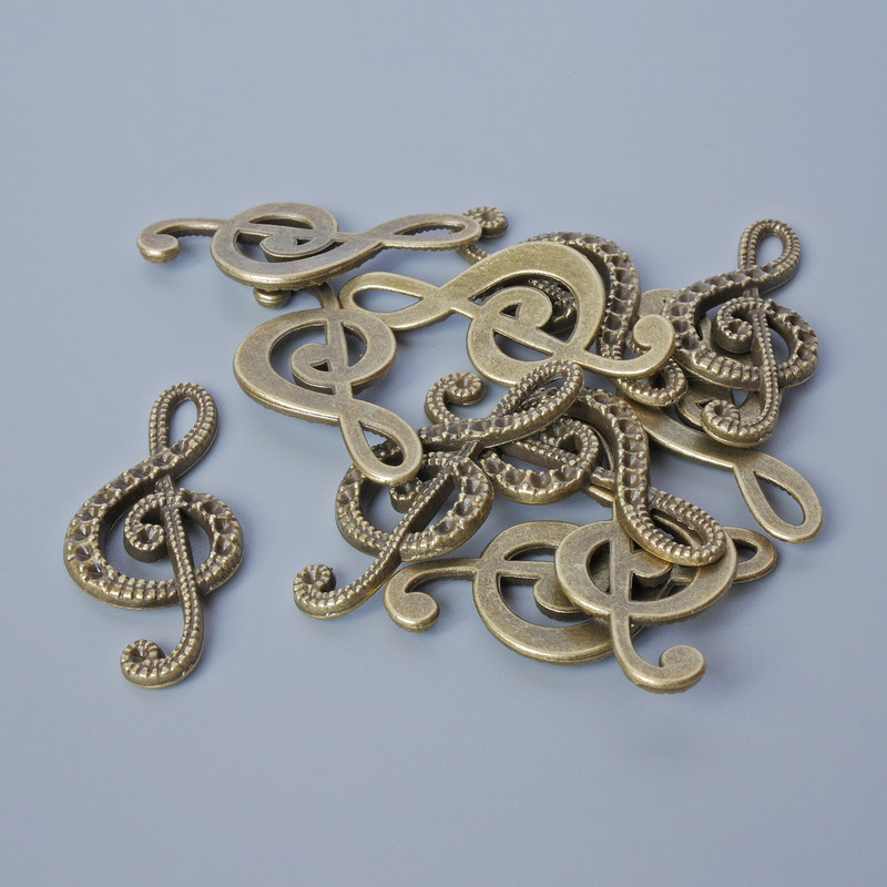 Zawieszka 'Klucz wiolinowy', średnica 33×14,5 mm, otwór 5,5×2 mm, opakowanie 11 szt. +/-, kolor metalu: brązowy