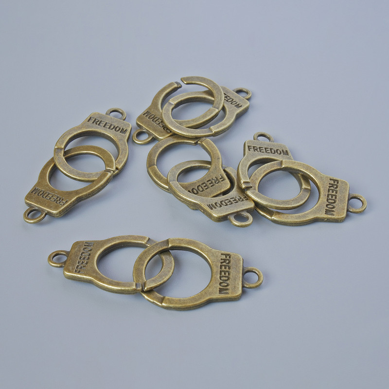 Zawieszka «Kajdanki», średnica 23×14 mm, grubość 5 mm, średnica otworu 2,4 mm, długość 40 mm, wykończenie fasetowe, opakowanie 5 szt. ±, kolor metalu: brązowy