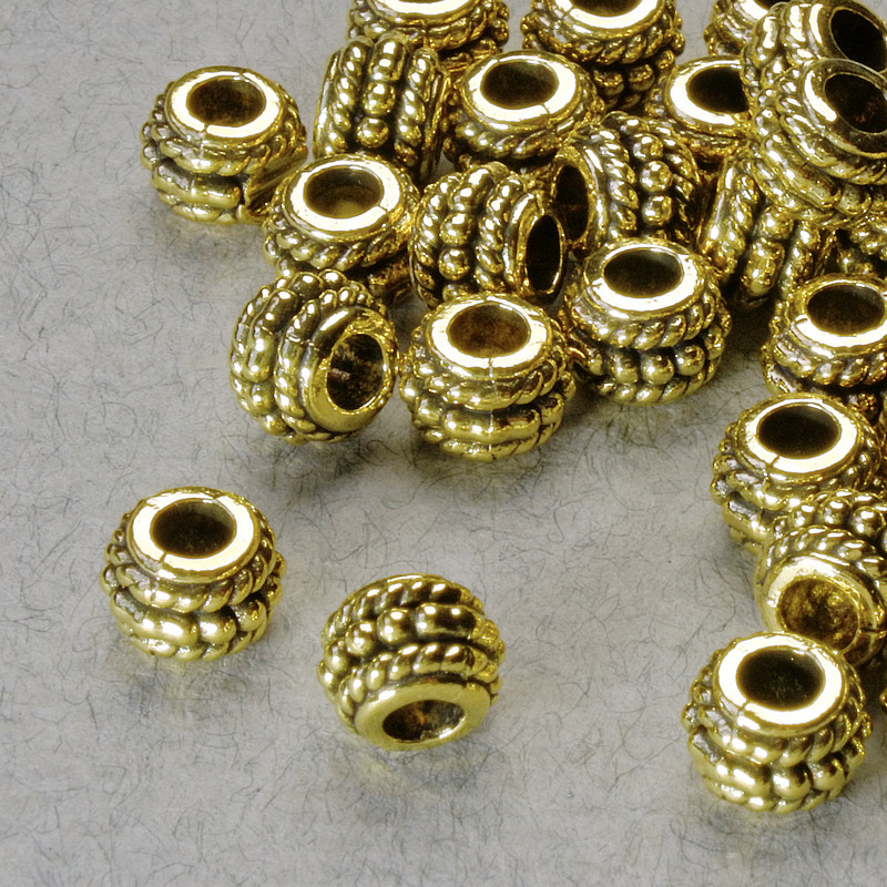 Złota koralikowa wstawka, średnica 5×6,5 mm, otwór 2,8 mm, złoty kolor metalu, op. 20 g +/- 38 szt.