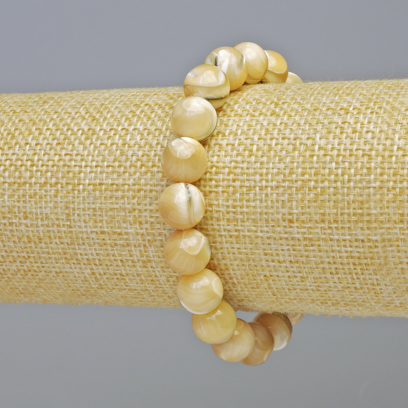 Bransoletka z naturalnej masy perłowej — gładkie kulki o średnicy około 10 mm, elastyczna, długość 18 cm+