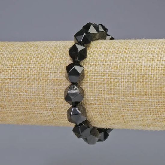 Bransoletka z srebrzystego obsydianu, fasetowane koraliki o średnicy około 10×12 mm, na elastycznej gumce, długość 18 cm+