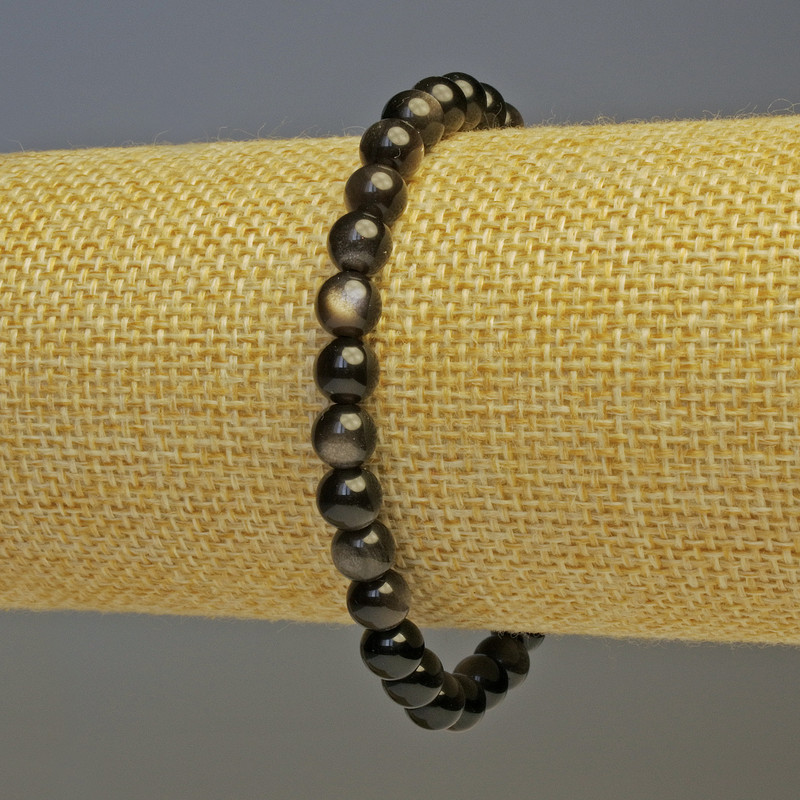 Bransoleta ze srebrzystego obsydianu, gładkie kulki o średnicy około 6 mm, długość 18 cm, elastyczna