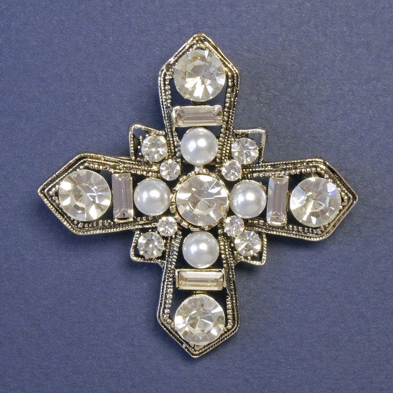 Broszka Krzyż Maltański wysadzany białymi perłami i strassami, o wymiarach 52×52 mm, w srebrzystym metalowym wykończeniu