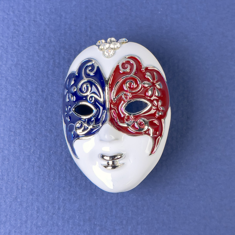 Broszka Maska: emalia biała, czarna i bordowa; srebrzysty metal, 27×39 mm