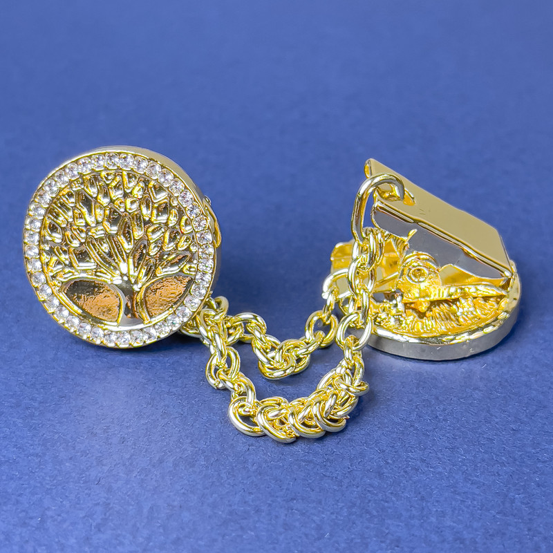 Broszka do kardiganów z złotym metalem, białymi cyrkoniami, średnica ok. 20 mm, łańcuszek, długość ok. 9 cm