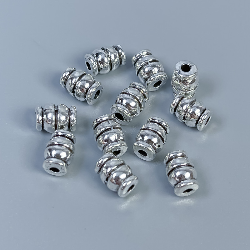 Furnitura jubilerska – koralik-wstawka srebrzysta, średnica 7×5 mm, otwór około 1,5 mm, opakowanie 28 szt.