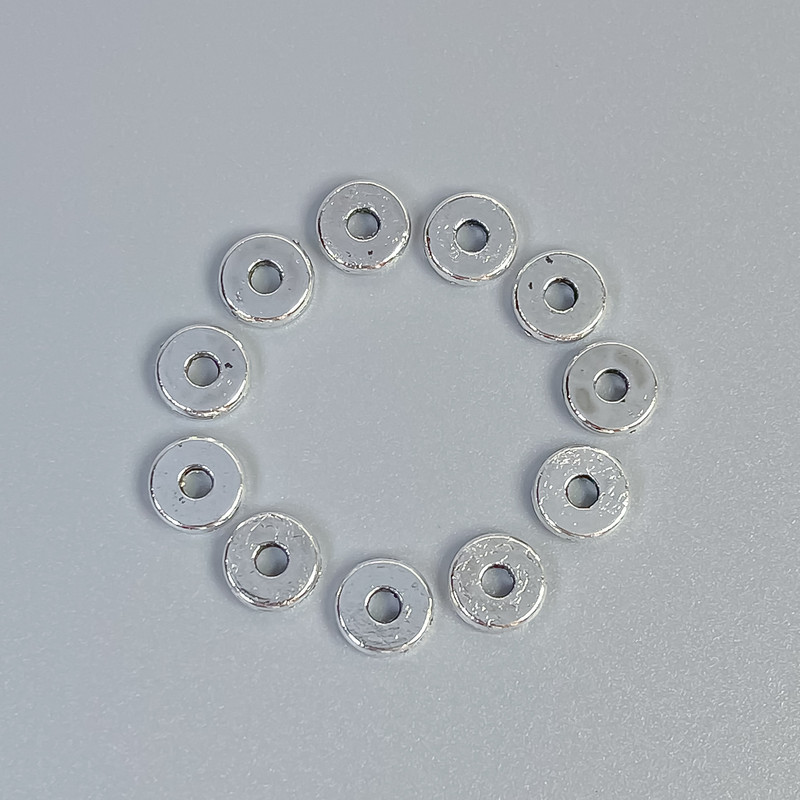 Koralik-wstawka do biżuterii, kolor metalu: srebro, średnica 6×1 mm, otwór ~1,5 mm, opakowanie 20 g (~100 szt.)