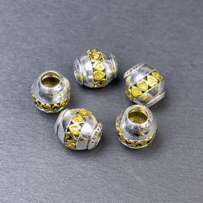 Koralik-wstawka o kolorze metalu srebrzysto-złotym, średnica 12×11 mm ± otwór 5 mm ± cena za 1 szt.
