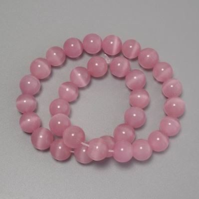Koraliki Kocie oko różowe, syntetyczny kamień, gładkie kuleczki o średnicy 12 mm na żyłce o długości około 37 cm