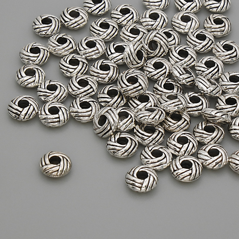 Akcesoria jubilerskie - koralik-wstawka w kolorze srebra, średnica 6×2,5 mm, otwór ~2 mm, opakowanie 20 g (~57 szt.)