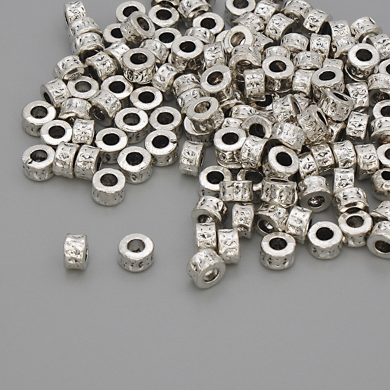 Furnitura: koralik-wstawka, kolor metalu: srebro, średnica 4×2,5 mm, otwór 2 mm, opakowanie 20 g (~128 szt.)