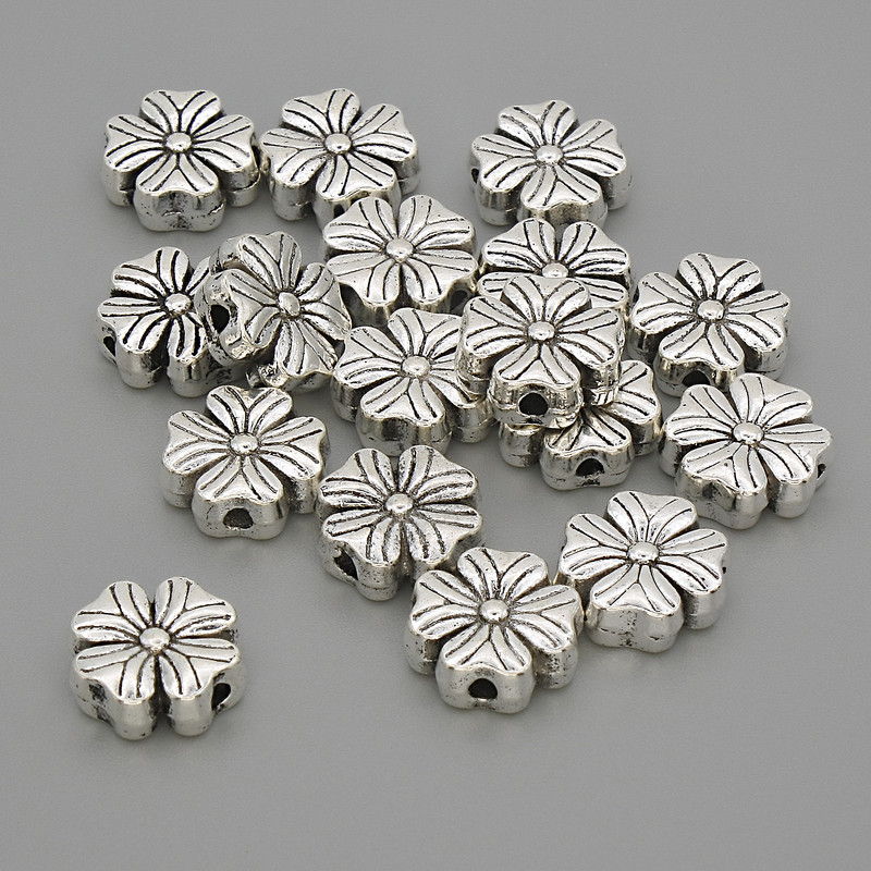 Koralik-wstawka 'Kwiat' kolor metalu: srebro, wymiary 9×9×3,5 mm, otwór 1,5 mm, opakowanie 20 g (~17 szt.)