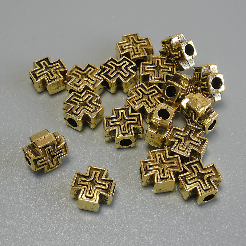 Koralik-wkładka w formie krzyża, złoty kolor metalu, wymiary 9×9×4,5 mm, otwór Ø 2,8 mm ±, opakowanie 20 g (~18 szt.)