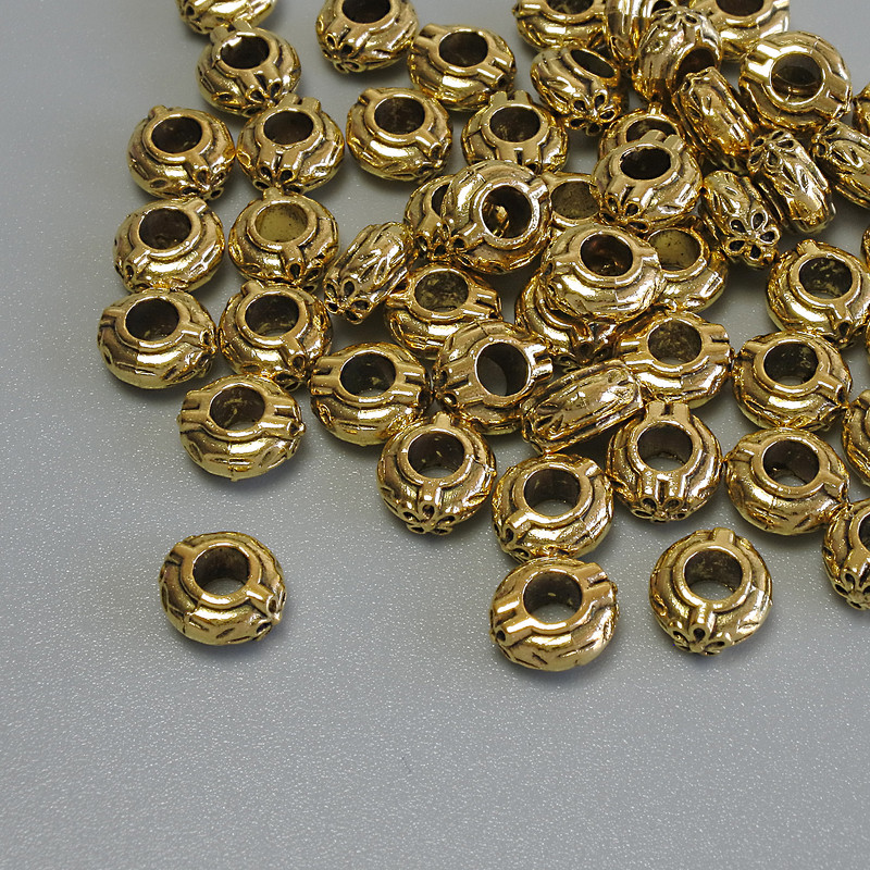 Elegancki koralik-wstawka w kolorze złotego metalu, średnica 6×3 mm, otwór około 3 mm, opakowanie 20 g (~56 szt.)