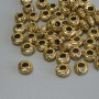 Elegancki koralik-wstawka w kolorze złotego metalu, średnica 6×3 mm, otwór około 3 mm, opakowanie 20 g (~56 szt.)