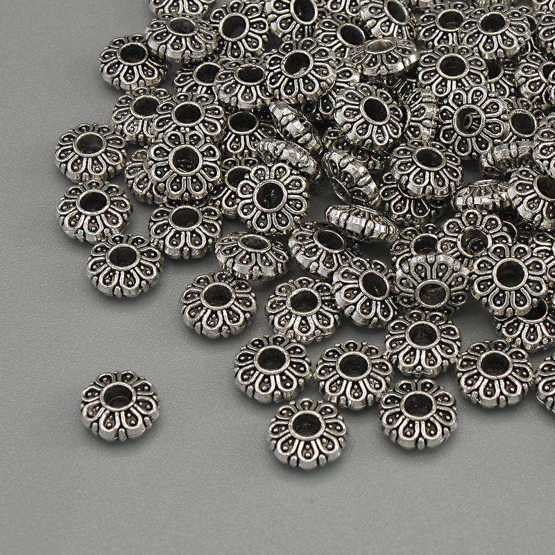 Wstawka koralikowa w kolorze metalu srebrnym, średnica 6×2,5 mm, otwór 2 mm, opakowanie 20 g (~94 szt.)