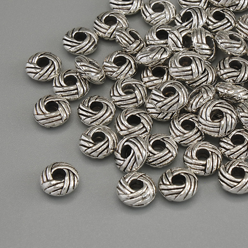 Okucia, koralik-wkładka w kolorze srebra, średnica 5×2,5 mm, otwór 2 mm ±, opakowanie 20 g (~56 szt.)
