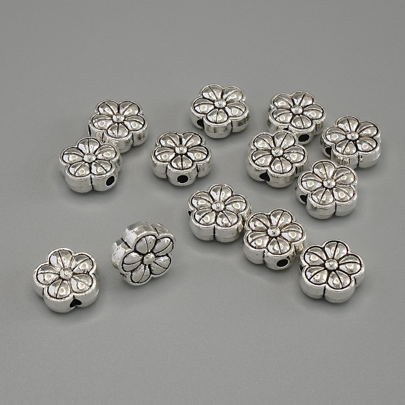 Koralik-wstawka 'Kwiat' kolor metalu: srebrny, średnica 10×4,5 mm ± otwór 2 mm ± opakowanie 20 g (~13 szt.)