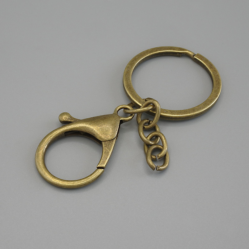 Cena za opakowanie /10 szt. Podstawa do breloka z dwoma zaczepami: karabinek 33×24 mm i pierścień, średnica 3 cm, długość 7 cm