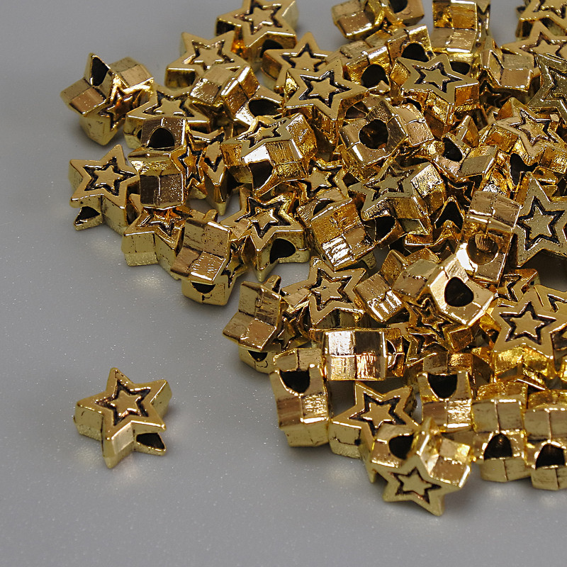 Koralik-wstawka gwiazdka w kolorze metalu złoto, średnica 6×3 mm, otwór ~2 mm, opakowanie 20 g (~70 szt.)