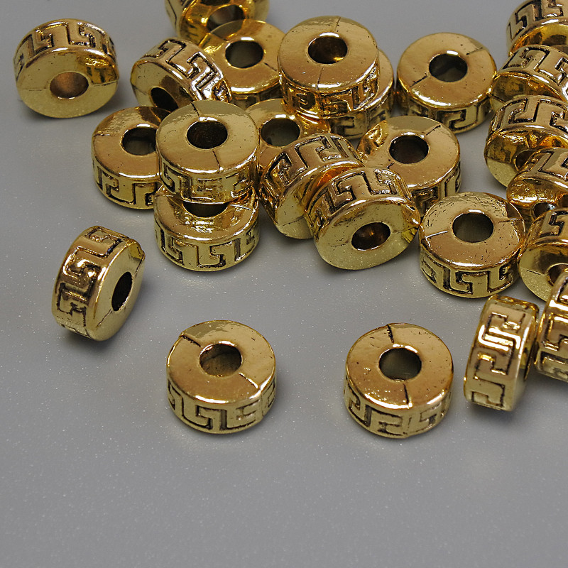 Koralik-wkładka kolor złoty, średnica 7×4 mm ± otwór, średnica 2,9 mm ± opakowanie 20 g (~25 szt.)