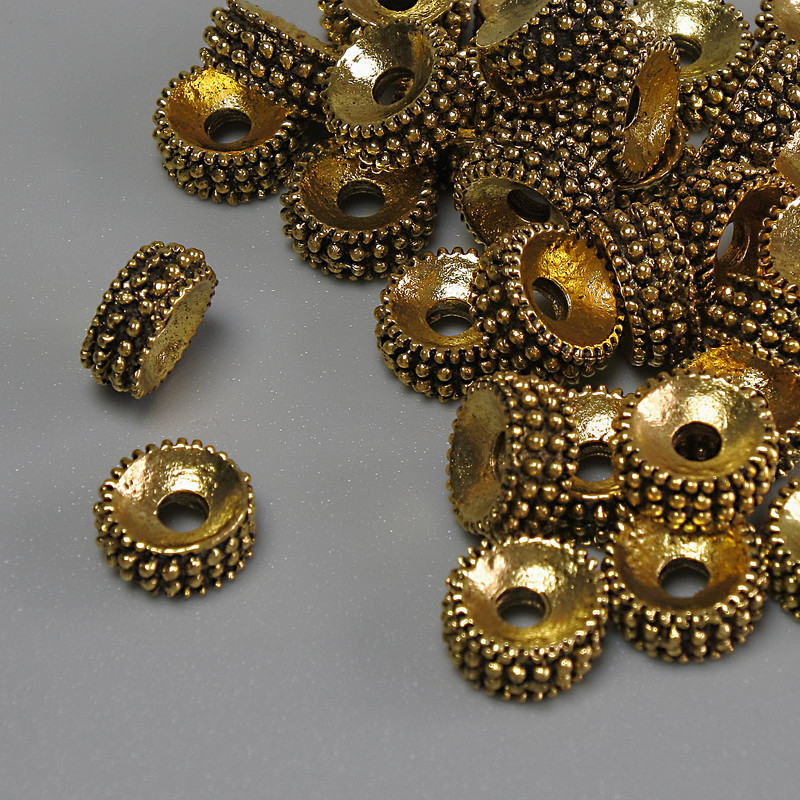 Koralik-wkładka w kolorze ciemnego złota, średnica 7,5×3,5 mm ± otwór 2,3 mm ± opakowanie 20 g (~35 szt.)