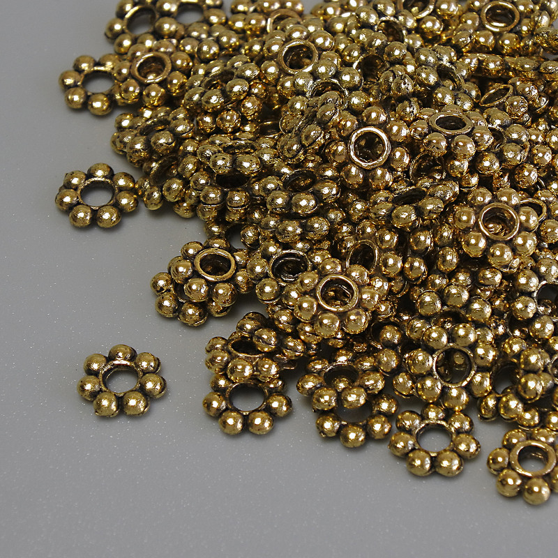 Koraliki-wstawki w kolorze złotego metalu, średnica 6×1,5 mm, otwór 2 mm, opakowanie 20 g (~132 szt.)