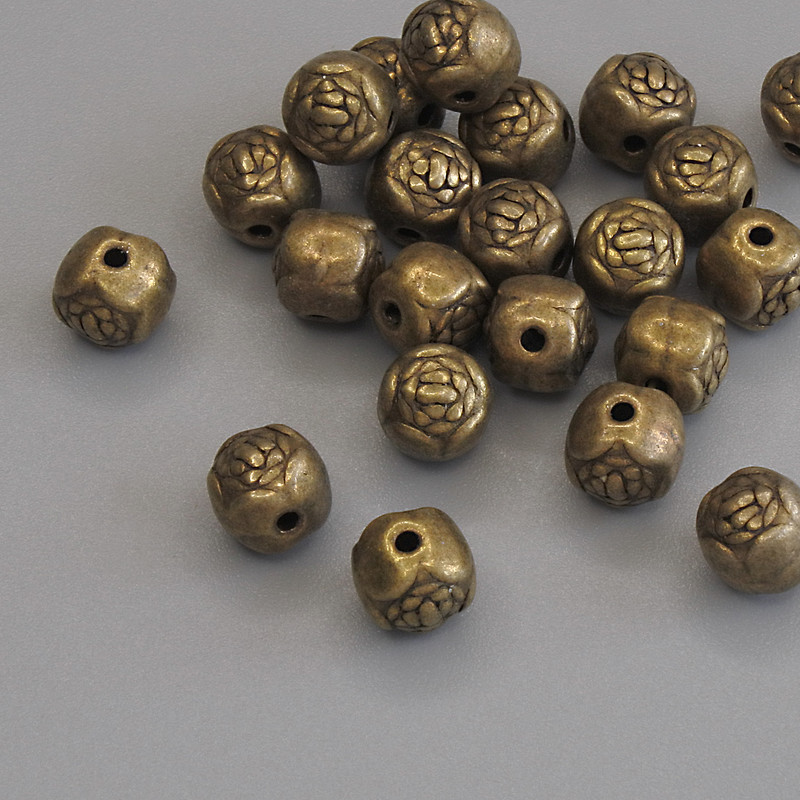 Koralik-wstawka w kolorze brązowego metalu, średnica 5,5×5,5 mm, otwór średnicy ok. 1,2 mm, opakowanie 23 szt.