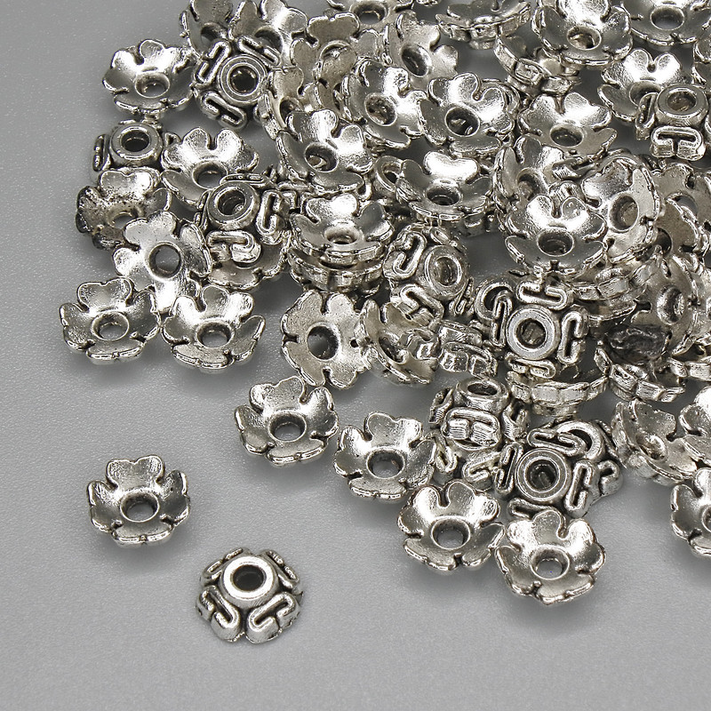 Kapeluszki do koralików, kolor metalu: srebrny, wymiary 6,5×1 mm, otwór około 1,8 mm, opakowanie 20 g (~88 szt.)