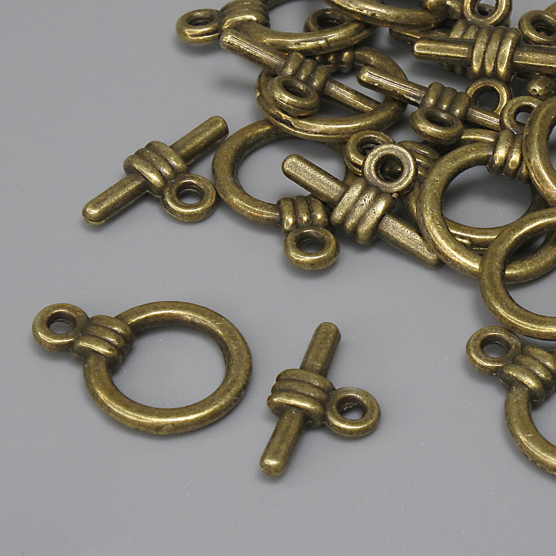 Zapięcie typu toggle, średnica 15×3 mm ±, koło średnica 9,5 mm ±, średnica otworu 7 mm ±, kolor metalu: brązowy, matowy, 15 szt.