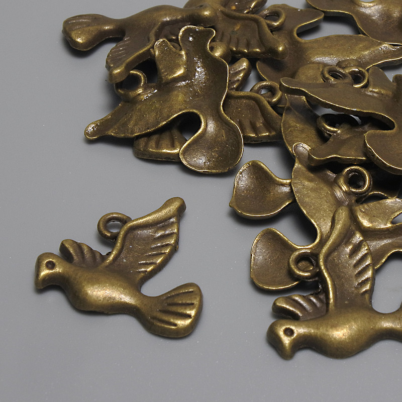 Zawieszka Ptaka, kolor metalu brązowy, średnica 19×18 mm, otwór 2 mm, opakowanie 17 szt.