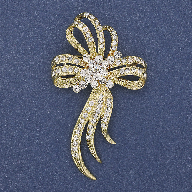 Broszka w formie kokardy, białe kryształki, złocisty metal, średnica 72×43 mm +