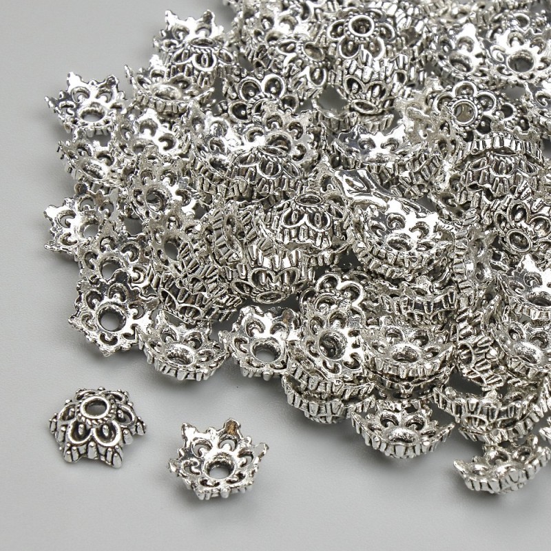 Furnitura kapeluszków do koralików, kolor metalu: srebrny, średnica 7 mm, otwór ~1,4 mm, opakowanie 20 g (~130 szt.)