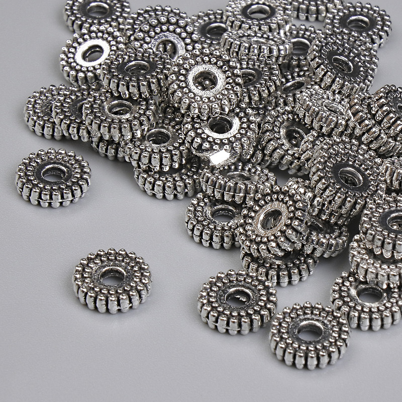 Koralik-wstawka o kolorze srebrnym, średnica 7×2 mm, otwór 2 mm, opakowanie 20 g ~58 szt.
