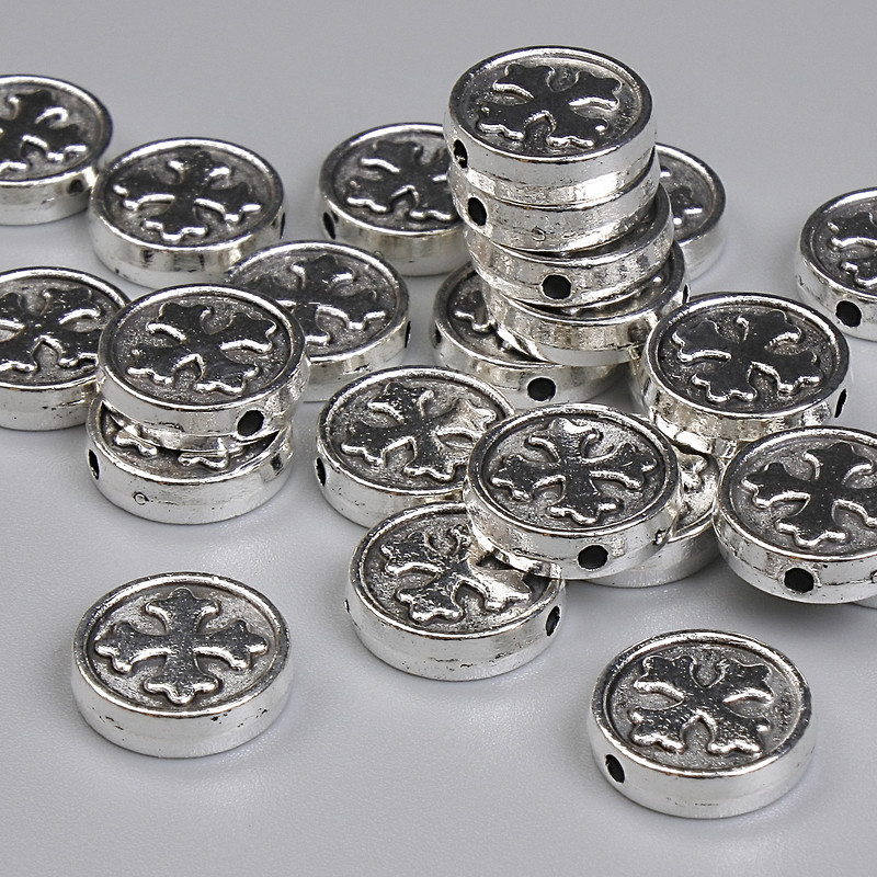 Koralik-wkładka w kształcie krzyża, kolor metalu: srebrny, średnica 9 mm ± otwór 1,4 mm ± opakowanie 20 g ~24 szt. +