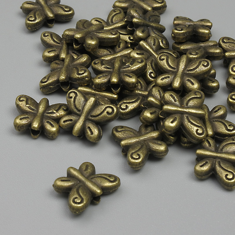 Koralik-wstawka w kształcie motyla, kolor metalu brązowy, wymiary 10x7 mm, 5x1 mm, średnica otworu 1,2 mm ±, opakowanie 20 g ~26 szt. +