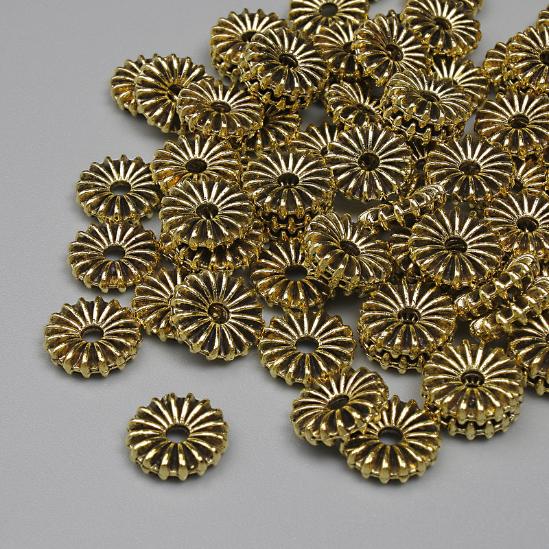 Koraliki-wkładki w kolorze złotym, średnica 7,5×2 mm, otwór 1,5 mm, opakowanie 20 g ≈ 68 szt.