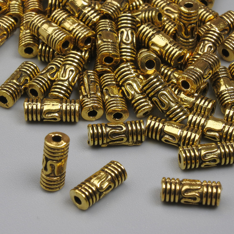 Koralik-wkładka w kolorze złota, wymiary 8×3,5 mm, średnica otworu około 1,2 mm, opakowanie 20 g (~56 szt.)