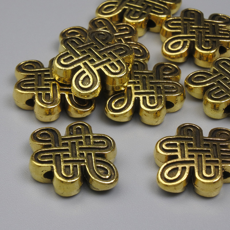 Koralik-wstawka „Węzeł nieskończoności” w kolorze złotego metalu, średnica 13×17 mm ±, otwór średnicy ok. 1,3 mm ±, opakowanie 20 g (~9 szt.)