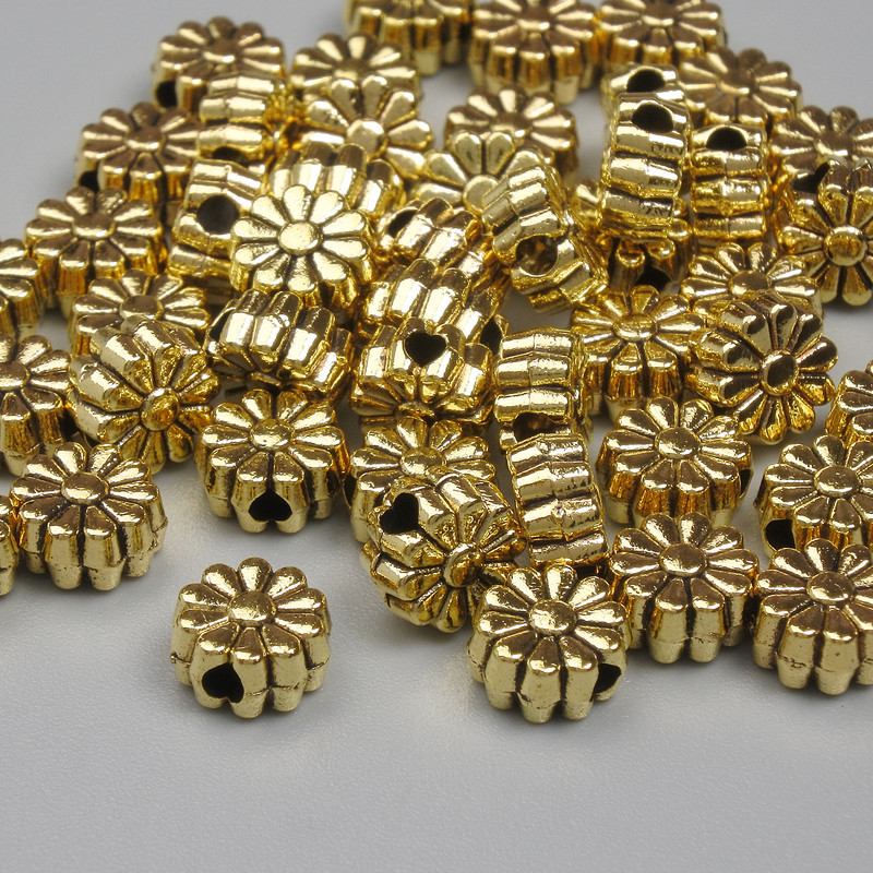 Koraliki-wkładki do biżuterii kolor metalu złoty, średnica 6×3 mm, otwór średnicy około 1,3 mm, opakowanie 20 g (~50 szt.)