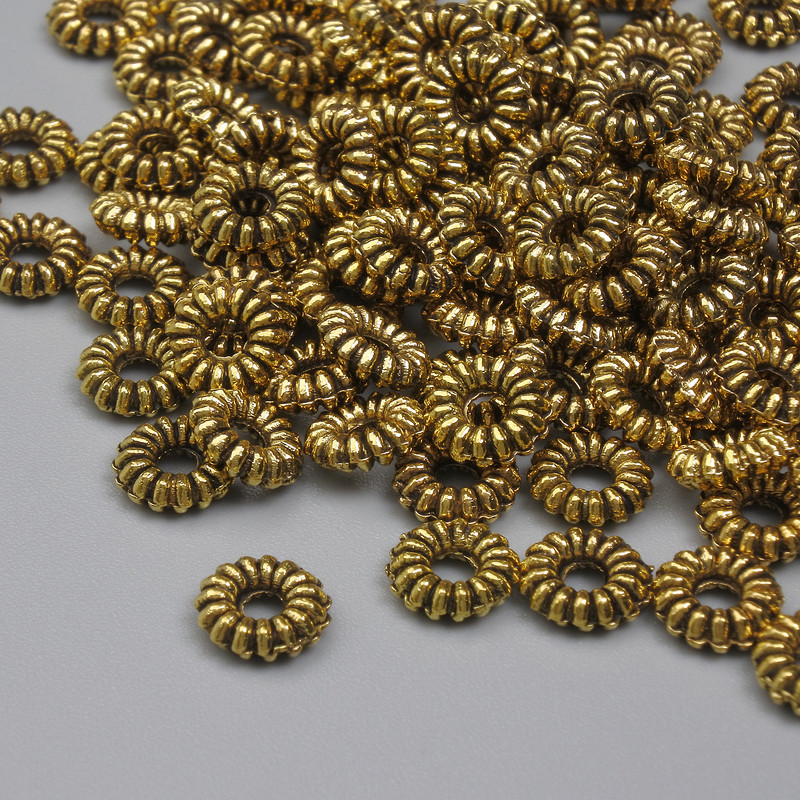 Koralik-wkładka, złoty kolor metalu, średnica 6×2 mm, otwór 2 mm, opakowanie 20 g (~94 szt.)