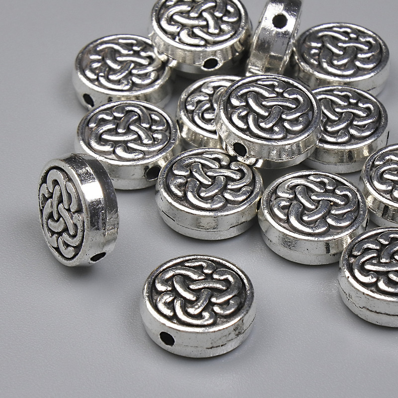 Koralik-wkładka, kolor metalu srebrny, średnica 9 mm ± otwór 1,2 mm ± opakowanie 20 g (~15 szt.)