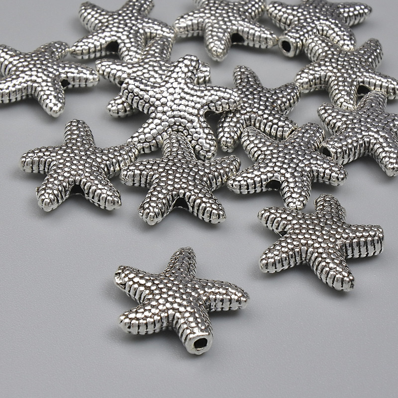 Koralik-wkładka gwiazda morska, kolor metalu: srebrny, średnica 14 mm ±, otwór 1,5 mm ±, opakowanie 20 g (~14 szt.)