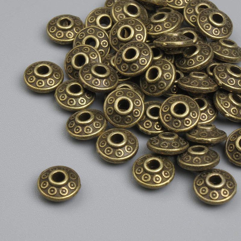 Koraliki-wstawki w kolorze brązu, kolor metalu: brązowy, średnica 6×3 mm, otwór 2,2 mm, opakowanie około 45 szt.