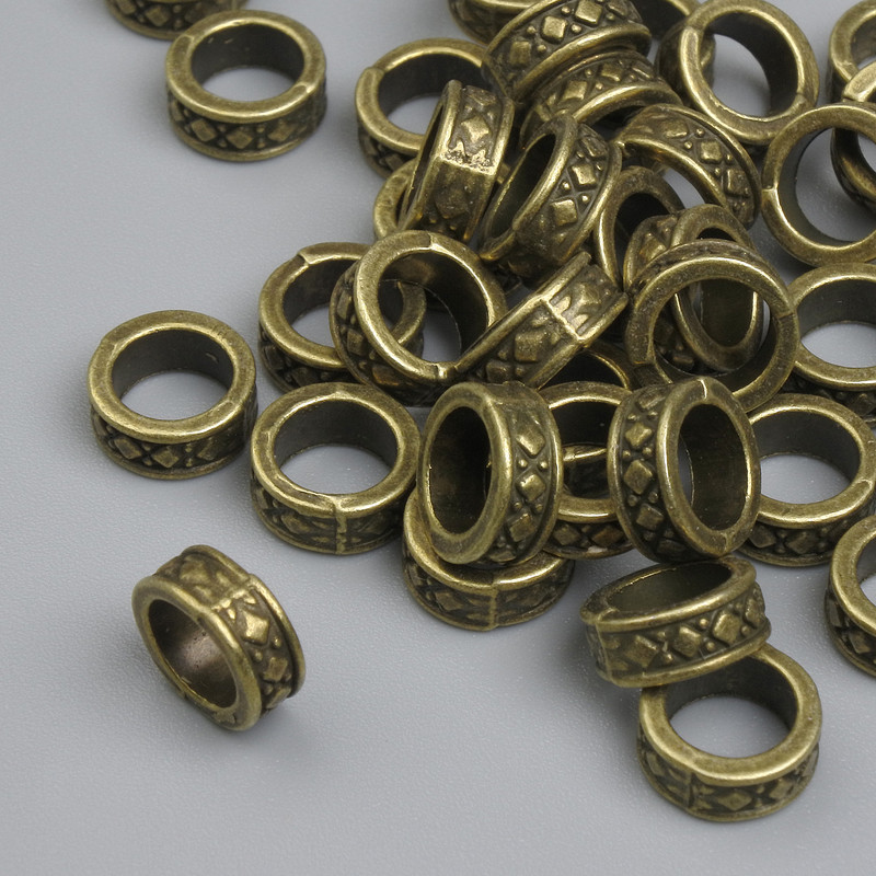 Koralik-wkładka brązowego koloru, wymiary 7,5×3 mm, otwór ~5 mm, opakowanie ~38 szt.